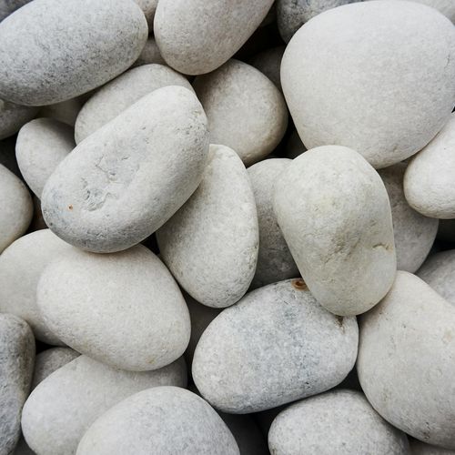 A stack of perfectly balanced stones on a neutral background.