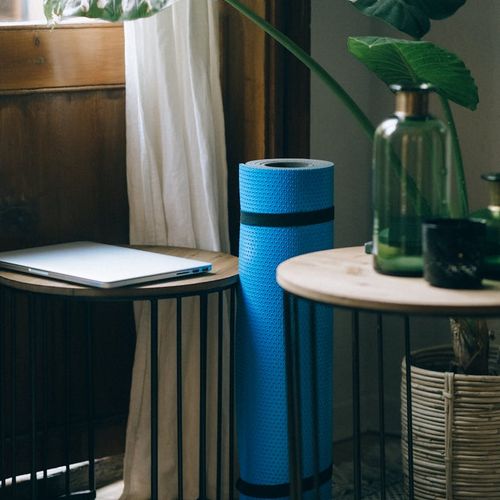 Empty, clean room with a yoga mat on the floor.